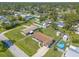 Bird's eye view displaying this property and the surrounding homes nestled amongst a backdrop of mature trees at 3044 Pine Tree Dr, Edgewater, FL 32141