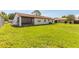 Spacious backyard with green grass and mature trees at 3044 Pine Tree Dr, Edgewater, FL 32141