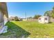 Large backyard with green grass and storage shed at 3044 Pine Tree Dr, Edgewater, FL 32141
