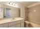 Bathroom with tiled shower-tub combination and a vanity with white cabinets at 3044 Pine Tree Dr, Edgewater, FL 32141