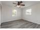 Bedroom with vinyl floors, ceiling fan, and two windows at 3044 Pine Tree Dr, Edgewater, FL 32141