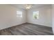 Bedroom with vinyl floors, two windows, and a ceiling fan at 3044 Pine Tree Dr, Edgewater, FL 32141