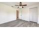 Bedroom with vinyl floors, ceiling fan, and closet at 3044 Pine Tree Dr, Edgewater, FL 32141