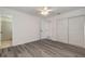 Bedroom with vinyl floors, ceiling fan, and closet, leading to bathroom at 3044 Pine Tree Dr, Edgewater, FL 32141