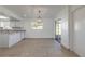 Bright dining area with tiled flooring, modern lighting, and access to an outdoor patio through sliding glass doors at 3044 Pine Tree Dr, Edgewater, FL 32141