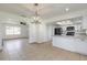 Open dining area with modern pendant lighting and open access to kitchen with white cabinetry at 3044 Pine Tree Dr, Edgewater, FL 32141