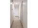 Hallway with neutral tile flooring with white walls, doors, and closet at 3044 Pine Tree Dr, Edgewater, FL 32141