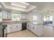 Bright kitchen features white cabinets, granite counters, and an outdoor patio access at 3044 Pine Tree Dr, Edgewater, FL 32141