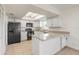 Bright kitchen features white cabinets, granite counters, and a full appliance package at 3044 Pine Tree Dr, Edgewater, FL 32141
