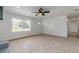 Bright and spacious living room boasts tile flooring, front window, and convenient access to other rooms at 3044 Pine Tree Dr, Edgewater, FL 32141