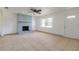 Inviting living room with tile flooring, blue brick fireplace, bright window, and a front door at 3044 Pine Tree Dr, Edgewater, FL 32141