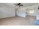 Spacious living room with tile flooring, ceiling fan, and open access to adjacent rooms at 3044 Pine Tree Dr, Edgewater, FL 32141