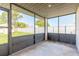Screened patio overlooking fenced backyard and lush landscaping at 3044 Pine Tree Dr, Edgewater, FL 32141