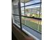 Enclosed balcony featuring views of the community pool, landscaping, and neighboring buildings at 315 N Causeway # 2060, New Smyrna Beach, FL 32169