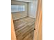 Bedroom with wood-look flooring and a window providing natural light at 315 N Causeway # 2060, New Smyrna Beach, FL 32169