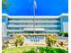 Waterway West building features an American flag, manicured grounds, and is conveniently located near shopping and amenities at 315 N Causeway # 2060, New Smyrna Beach, FL 32169