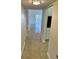 Hallway with tile flooring leading to a bright living area with neutral walls and plenty of natural light at 315 N Causeway # 2060, New Smyrna Beach, FL 32169