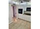 Kitchen with white cabinets, black oven, stainless appliances, and tile flooring at 315 N Causeway # 2060, New Smyrna Beach, FL 32169