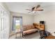 Cozy bedroom with a futon sofa, desk and a window bringing in natural light at 3231 Bretton Woods Ter, Deltona, FL 32725