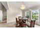 Cozy dining area with a round table, chandelier, and a view of the backyard at 3231 Bretton Woods Ter, Deltona, FL 32725