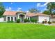 Charming single-story home with a lush green lawn, well-manicured landscaping, and a durable metal roof at 3231 Bretton Woods Ter, Deltona, FL 32725