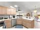 Bright kitchen featuring light wood cabinetry, stainless steel appliances, and a cozy breakfast bar at 3231 Bretton Woods Ter, Deltona, FL 32725