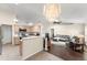 Open-concept living room and kitchen with hardwood floors, modern appliances, and recessed lighting at 3231 Bretton Woods Ter, Deltona, FL 32725
