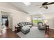 Comfortable living room featuring a plush sofa, ceiling fan, and view of the landscaped yard at 3231 Bretton Woods Ter, Deltona, FL 32725