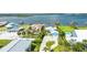 Aerial view of waterfront home, featuring a pool, ample parking, and lush tropical landscaping at 3326 S Peninsula Dr, Port Orange, FL 32127