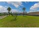 Wide angle view of a green backyard, screened in pool and water at 3326 S Peninsula Dr, Port Orange, FL 32127