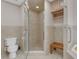 Bright bathroom showcasing a glass enclosed shower, toilet, and vanity with storage shelves at 3326 S Peninsula Dr, Port Orange, FL 32127