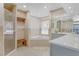 A well-lit bathroom featuring a glass shower, soaking tub, and vanity with storage at 3326 S Peninsula Dr, Port Orange, FL 32127