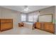 A tidy bedroom featuring neutral walls, and wooden furniture on a tiled floor at 3326 S Peninsula Dr, Port Orange, FL 32127