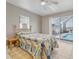 Bedroom with a ceiling fan and access to a screened in pool area at 3326 S Peninsula Dr, Port Orange, FL 32127