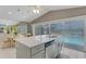 Gourmet kitchen provides quartz counters, an island sink, and views of the pool and waterfront at 3326 S Peninsula Dr, Port Orange, FL 32127