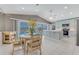 Kitchen and dining area with a view of the screened-in pool and waterfront at 3326 S Peninsula Dr, Port Orange, FL 32127