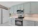 Bright kitchen features modern appliances, quartz countertops, and soft-close cabinetry at 3326 S Peninsula Dr, Port Orange, FL 32127