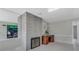 Bright living room showcasing a stone fireplace and a classic wooden desk at 3326 S Peninsula Dr, Port Orange, FL 32127