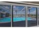 Covered screened lanai with a waterfront pool, and a dining area at 3326 S Peninsula Dr, Port Orange, FL 32127