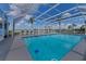 Large screened in pool with tables and chairs ready for entertaining at 3326 S Peninsula Dr, Port Orange, FL 32127