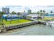 Rear exterior view of a waterfront property with a dock, pool, and lush landscaping at 3326 S Peninsula Dr, Port Orange, FL 32127