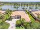 Stunning aerial view of the home with a tile roof, manicured lawn, and lake in the background at 3577 Maribella Dr, New Smyrna Beach, FL 32168