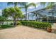 Large backyard with an exterior patio, landscaping and screened pool at 3577 Maribella Dr, New Smyrna Beach, FL 32168