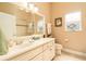 Cozy bathroom featuring a clean vanity, ample mirror, and a shower over tub with natural light at 3577 Maribella Dr, New Smyrna Beach, FL 32168