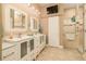 Modern bathroom featuring double sinks, a sleek white vanity, and a glass-enclosed shower with tile accents at 3577 Maribella Dr, New Smyrna Beach, FL 32168