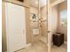Shower with glass door, decorative tile border and natural light, accompanied by a sliding barn door entrance at 3577 Maribella Dr, New Smyrna Beach, FL 32168