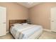 Comfortable bedroom featuring a wooden headboard bed, light blue bedding and neutral colored walls at 3577 Maribella Dr, New Smyrna Beach, FL 32168