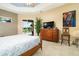 Serene main bedroom with tray ceilings, tile floors, and sliding glass doors to the outdoor patio at 3577 Maribella Dr, New Smyrna Beach, FL 32168