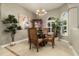 The dining room features a glass table, chandelier, plants, and neutral paint at 3577 Maribella Dr, New Smyrna Beach, FL 32168