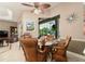 Dining area with glass top table, woven chairs, and ample natural light at 3577 Maribella Dr, New Smyrna Beach, FL 32168